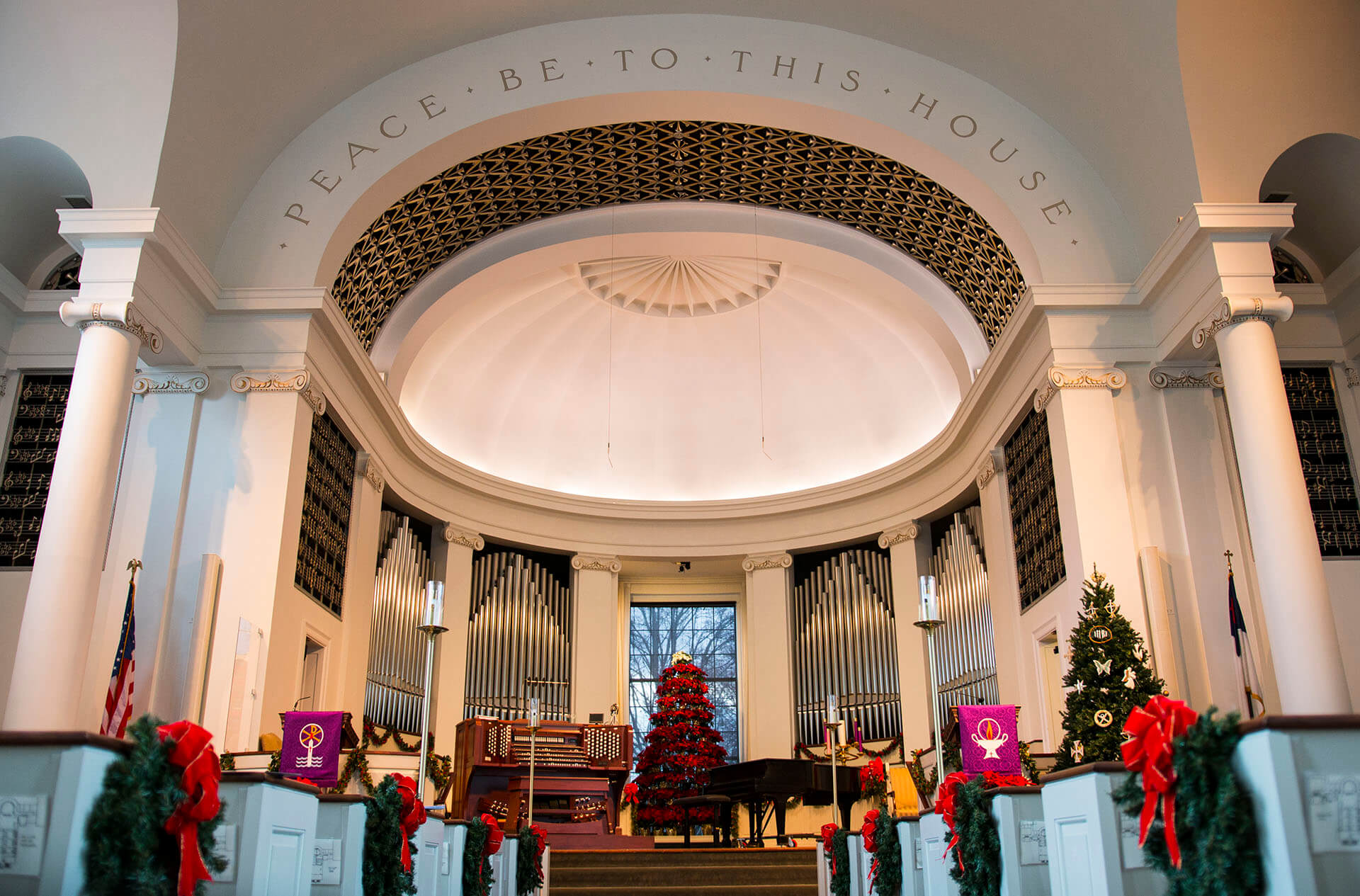 A large church with a christmas tree and decorations.