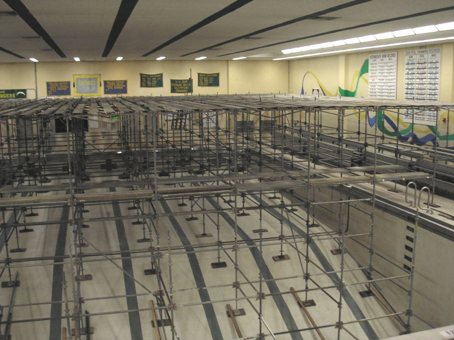 A large room with many metal scaffolding on the floor.