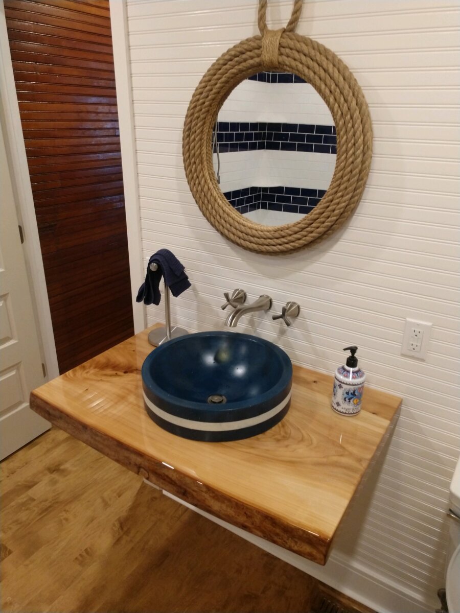 A bathroom with a sink and mirror on the wall