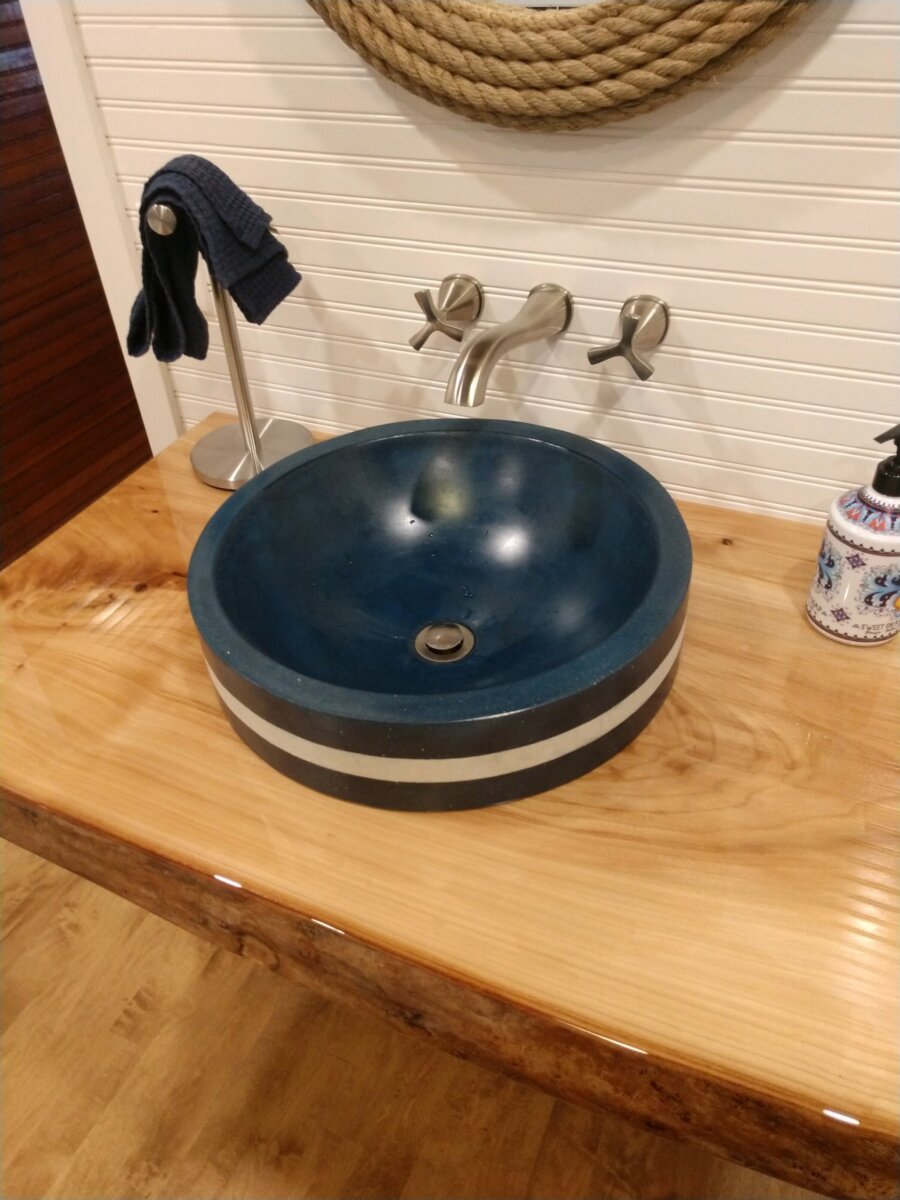 A blue bowl sitting on top of a wooden table.