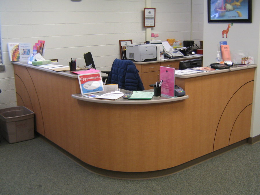 A group of people sitting at the front desk.