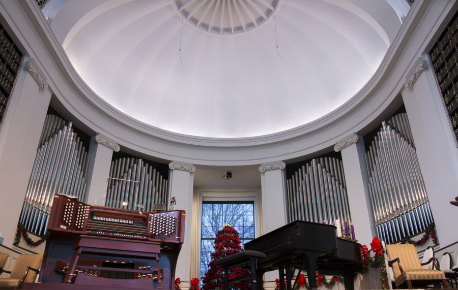 A piano and organ in the center of a room.