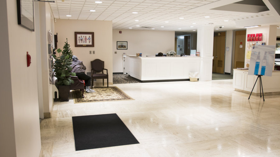 A lobby with a christmas tree and a waiting room.