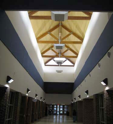 A hallway with lights and a ceiling.