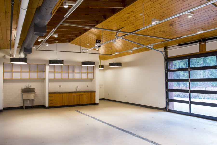 A garage with wood paneling and white walls.