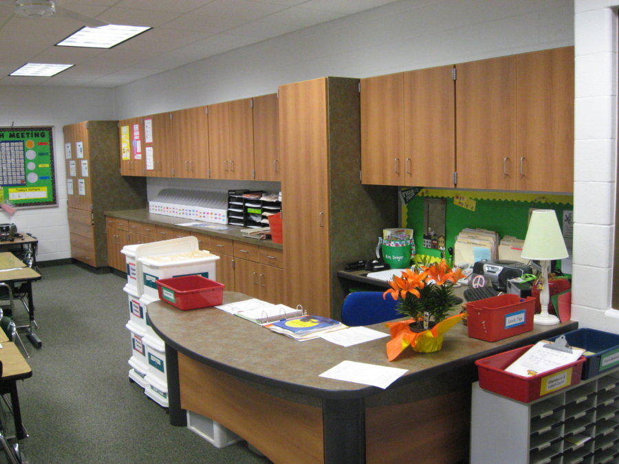 A room with many cabinets and papers on the counter