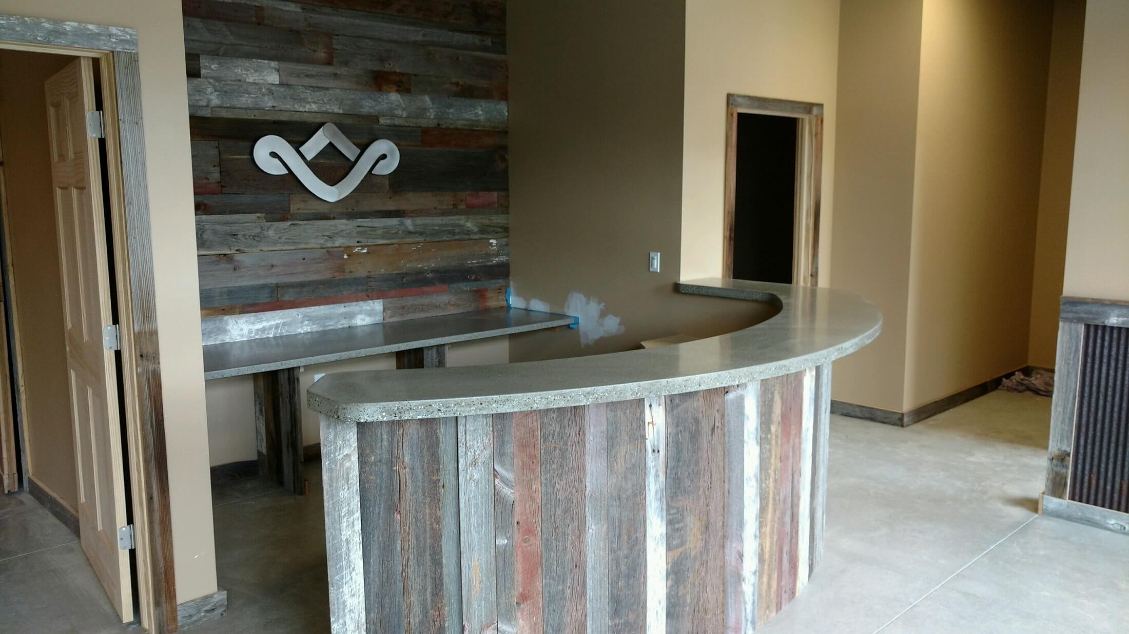 A wooden bar with a stone counter top.